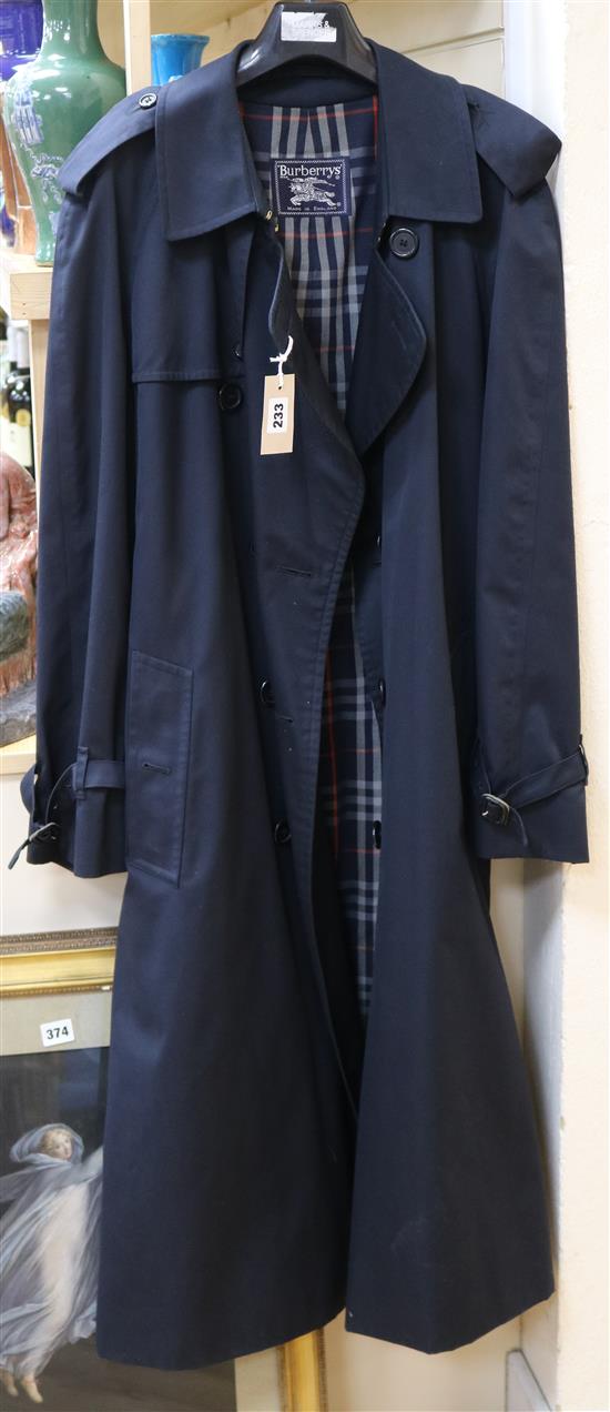 A Burberry navy blue trench coat, size 52R